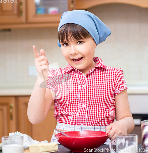 Image of Girl is cooking in kitchen