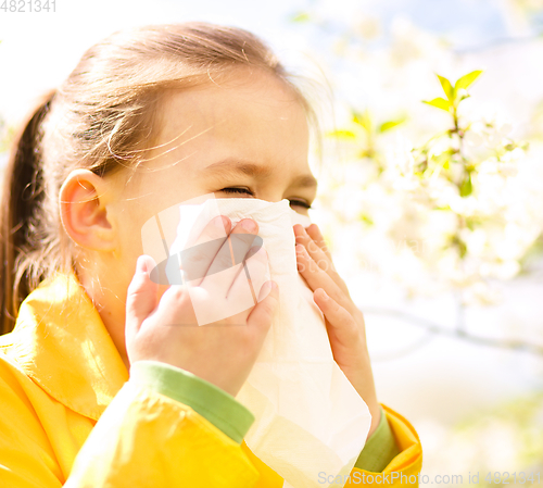 Image of Little girl is blowing her nose