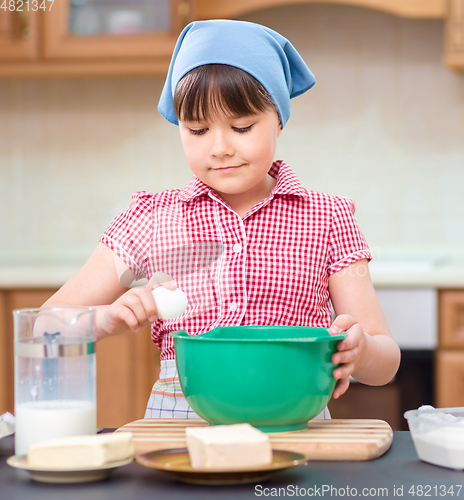 Image of Girl is cooking in kitchen