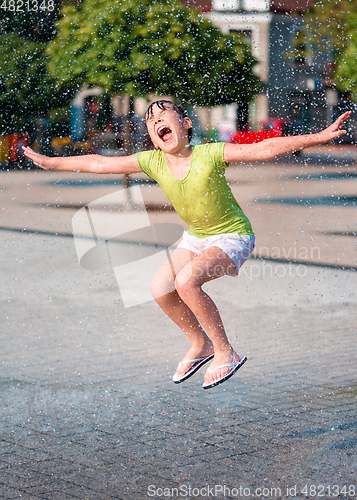 Image of Girl is running through fountains