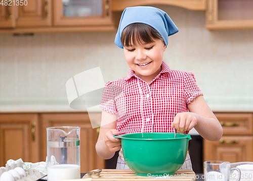 Image of Girl is cooking in kitchen