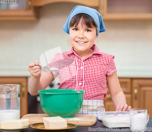 Image of Girl is cooking in kitchen