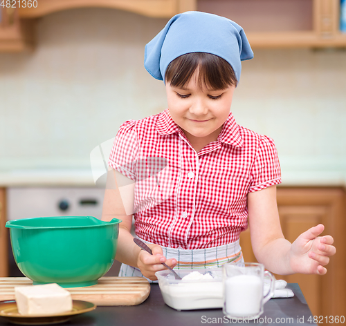 Image of Girl is cooking in kitchen