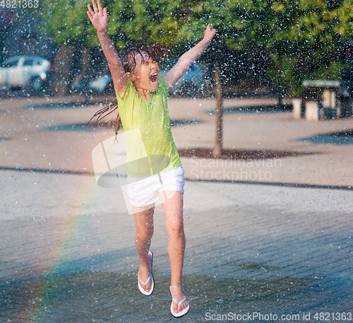 Image of Girl is running through fountains