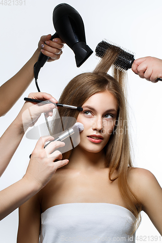 Image of beautiful girl getting hair and makeup