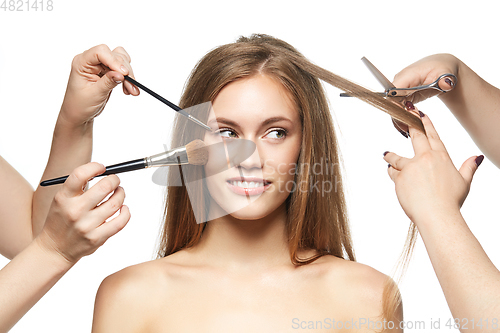 Image of beautiful girl getting haircut