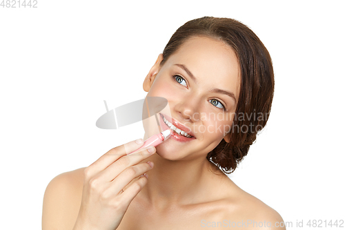 Image of girl applying lipgloss