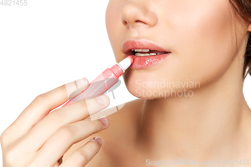 Image of girl applying lipgloss