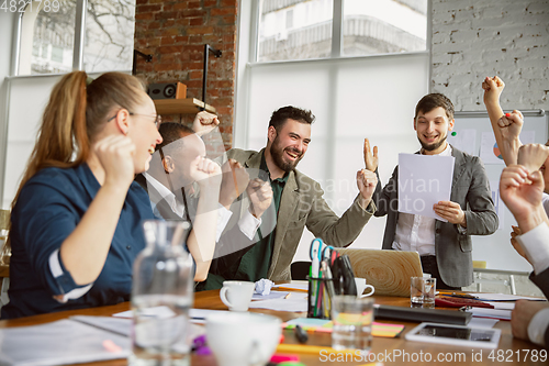Image of Group of young business professionals having a meeting, creative office