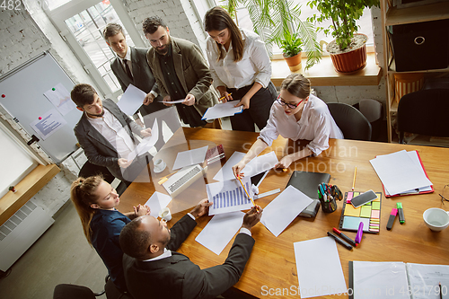 Image of Group of young business professionals having a meeting, creative office