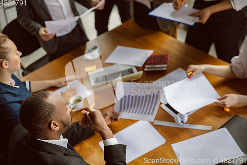 Image of Group of young business professionals having a meeting, creative office