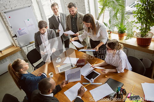 Image of Group of young business professionals having a meeting, creative office