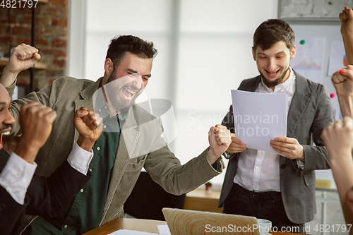 Image of Group of young business professionals having a meeting, creative office