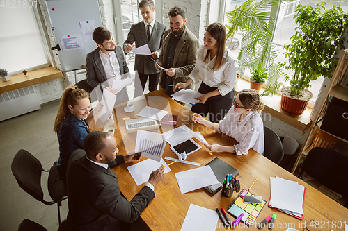 Image of Group of young business professionals having a meeting, creative office