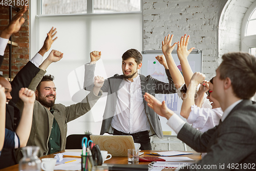 Image of Group of young business professionals having a meeting, creative office