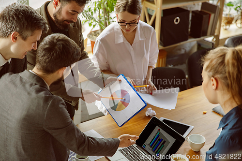 Image of Group of young business professionals having a meeting, creative office