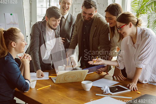 Image of Group of young business professionals having a meeting, creative office