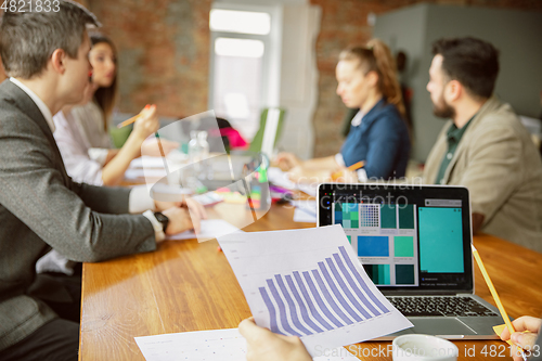 Image of Group of young business professionals having a meeting, creative office