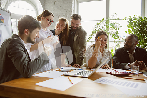 Image of Group of young business professionals having a meeting, creative office