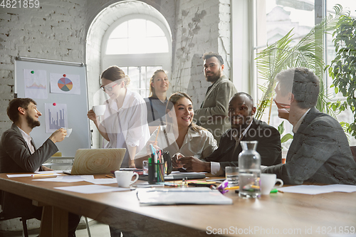 Image of Group of young business professionals having a meeting, creative office