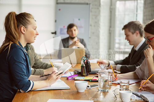 Image of Group of young business professionals having a meeting, creative office