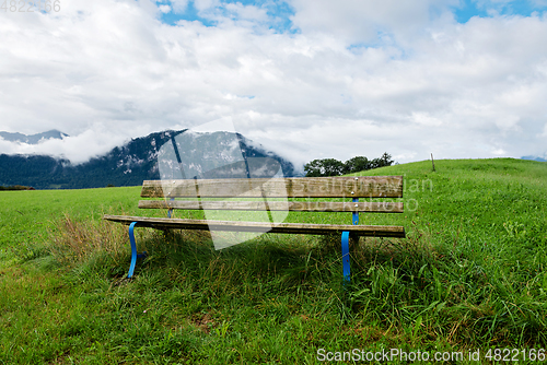 Image of A calm place to rest and relax. An empty wooden bench. Switzerland