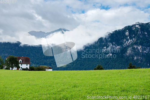 Image of Beautiful mountains landscape in Switzerland Alps. Small house