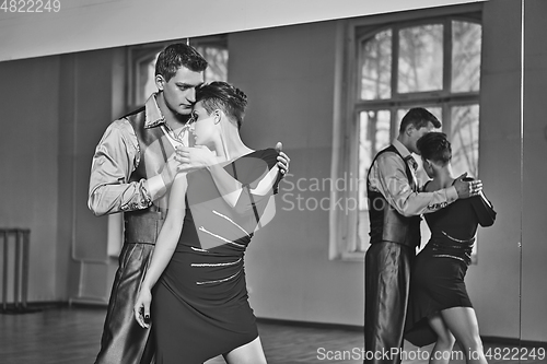 Image of beautiful couple dancing tango