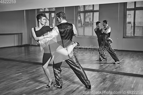 Image of beautiful couple dancing tango