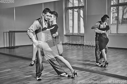 Image of beautiful couple dancing tango