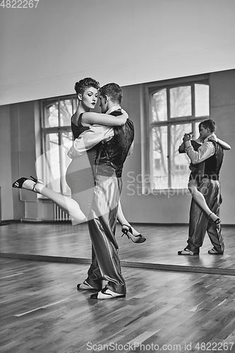 Image of beautiful couple dancing tango