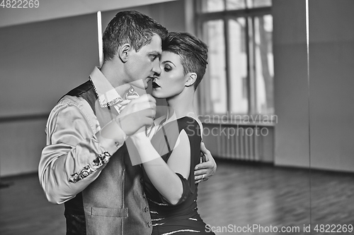 Image of beautiful couple dancing tango