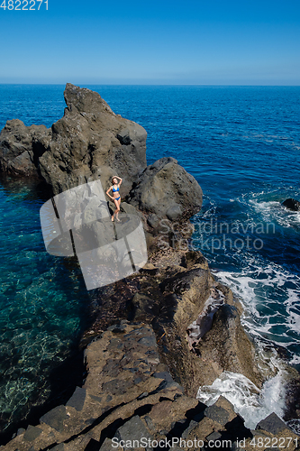 Image of beautiful girl resting in natural ocean swimming pool