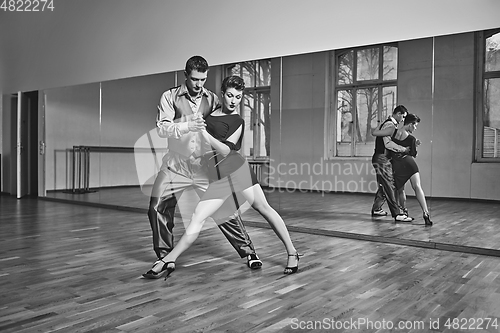 Image of beautiful couple dancing tango