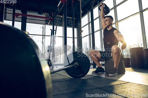 Image of The male athlete training hard in the gym. Fitness and healthy life concept.