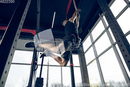 Image of The male athlete training hard in the gym. Fitness and healthy life concept.