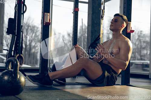 Image of The male athlete training hard in the gym. Fitness and healthy life concept.