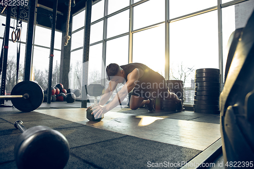 Image of The male athlete training hard in the gym. Fitness and healthy life concept.