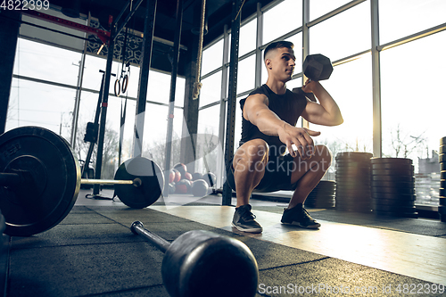 Image of The male athlete training hard in the gym. Fitness and healthy life concept.