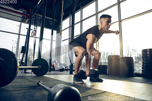 Image of The male athlete training hard in the gym. Fitness and healthy life concept.