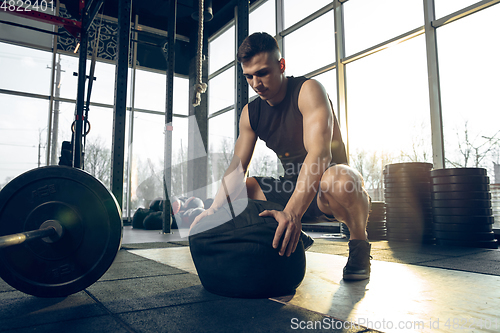 Image of The male athlete training hard in the gym. Fitness and healthy life concept.