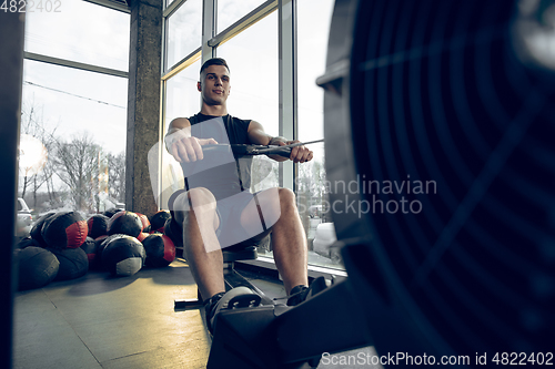 Image of The male athlete training hard in the gym. Fitness and healthy life concept.