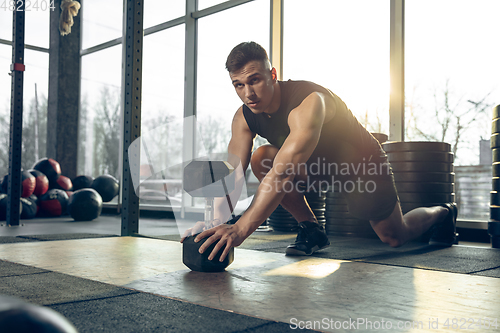 Image of The male athlete training hard in the gym. Fitness and healthy life concept.
