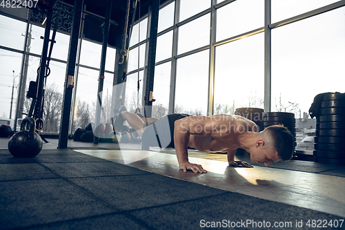 Image of The male athlete training hard in the gym. Fitness and healthy life concept.