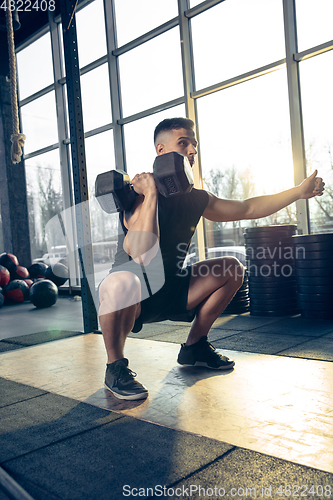 Image of The male athlete training hard in the gym. Fitness and healthy life concept.