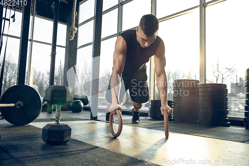 Image of The male athlete training hard in the gym. Fitness and healthy life concept.