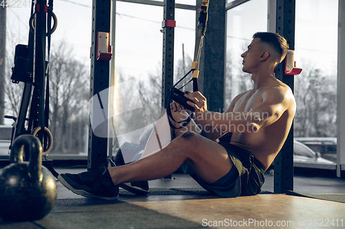 Image of The male athlete training hard in the gym. Fitness and healthy life concept.