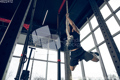 Image of The male athlete training hard in the gym. Fitness and healthy life concept.