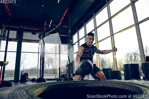 Image of The male athlete training hard in the gym. Fitness and healthy life concept.