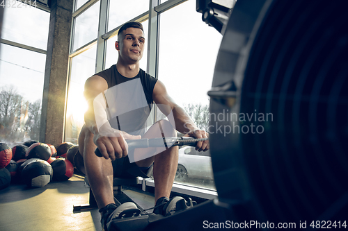 Image of The male athlete training hard in the gym. Fitness and healthy life concept.
